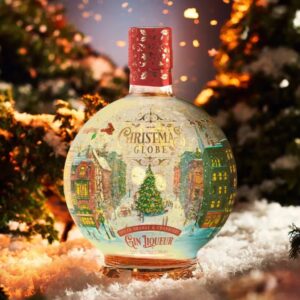 Spherical Christmas Snow Globe Gin Liqueur bottle, Spiced Orange & Cranberry flavour, featuring an illuminated holiday street scene and internal gold shimmer, set in a snowy landscape with twinkling Christmas lights.