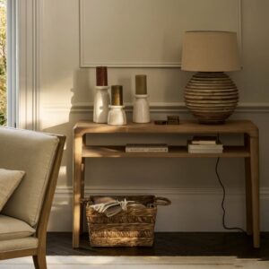 Solid oak console table with clean, minimalist lines, featuring long tapered legs and a smooth top surface, ideal for an entryway or hallway, styled in a bright, modern interior.