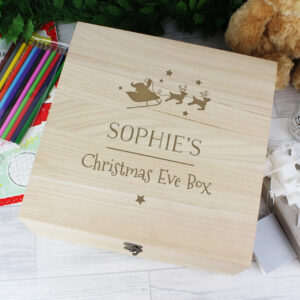 Large personalised wooden Christmas Eve box with a hinged lid and metal clasp, engraved with a name, 'Christmas Eve Box,' and Santa's sleigh silhouette.