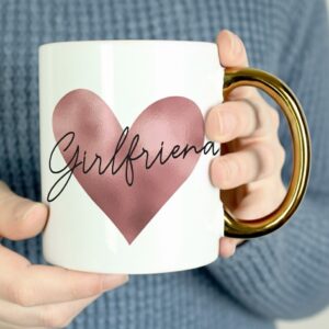 person holding white mug with girlfriend text metallic heart