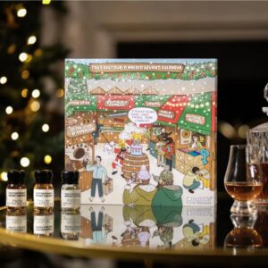 That Boutique-y Whisky Company Advent Calendar, a premium box featuring 24 wax-sealed drams of single malt and blended whiskies, displayed in a sophisticated, dark-colored presentation.