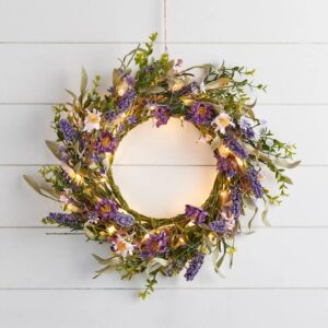 45cm Spring Lavender Wreath: A 45cm spring wreath featuring faux purple lavender, wildflowers, and green foliage with glowing warm white micro LED lights, hanging on a white wooden shiplap wall.