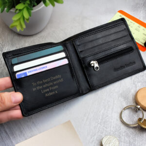 Personalised Black Leather Wallet: A professional photo of a sleek black leather bi-fold wallet. The engraving is clearly visible on the bottom corner, showcasing the custom initials against the smooth black leather finish.