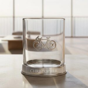 Personalised Cycling Pewter Tumbler: A luxury glass tumbler with a weighted pewter base engraved with the name "CHRISTOPHER." The side of the glass features a detailed, raised pewter road bike icon.