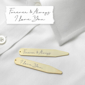 A pair of luxurious 18K gold-plated collar stiffeners resting on a crisp white dress shirt. The stiffeners are engraved with genuine handwriting; the top one reads "Forever & Always" and the bottom one reads "I Love You." Above the shirt, a white paper strip shows the original handwritten note.