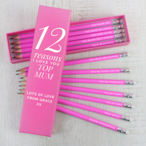 Personalised 12 Reasons Box: A vibrant pink pencil box set with a lid customised with "12 Reasons I Love You Top Mum" from "Grace." Twelve matching pink pencils are fanned out, each engraved with a different reason like "YOU MADE ME!" and "YOUR SMILE."