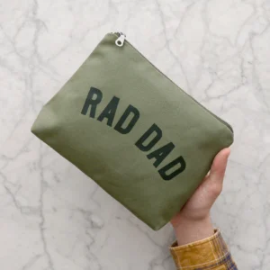 Rad Dad olive green canvas wash bag with waterproof lining held in hand